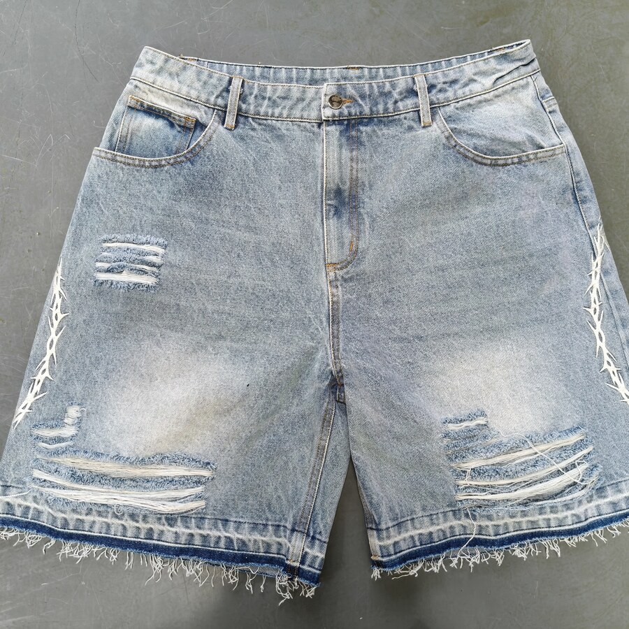 Finished light denim shorts with distressed openings and frayed hems