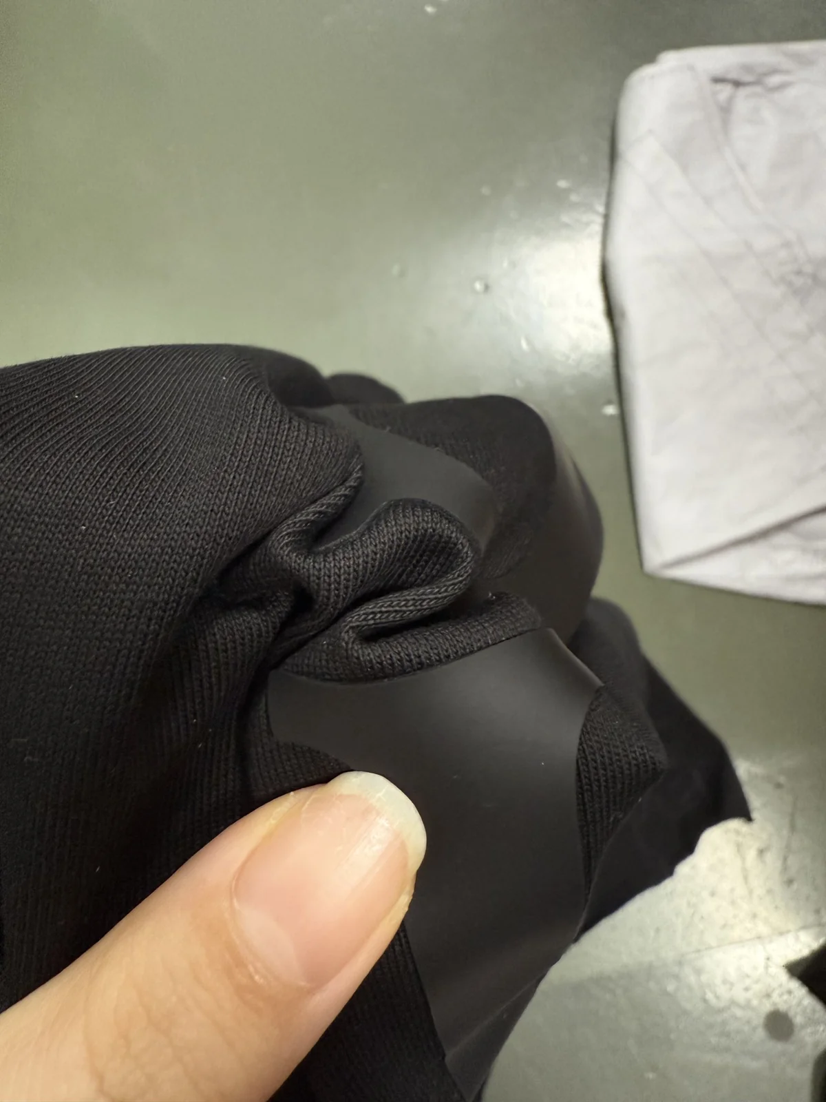 Close-up of the smooth raised silicone surface on black fabric