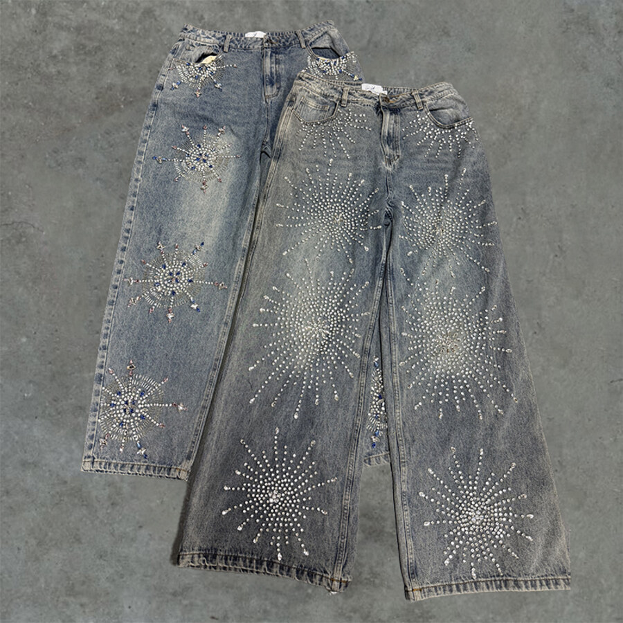 Two pairs of finished jeans with decorative hardware on the legs
