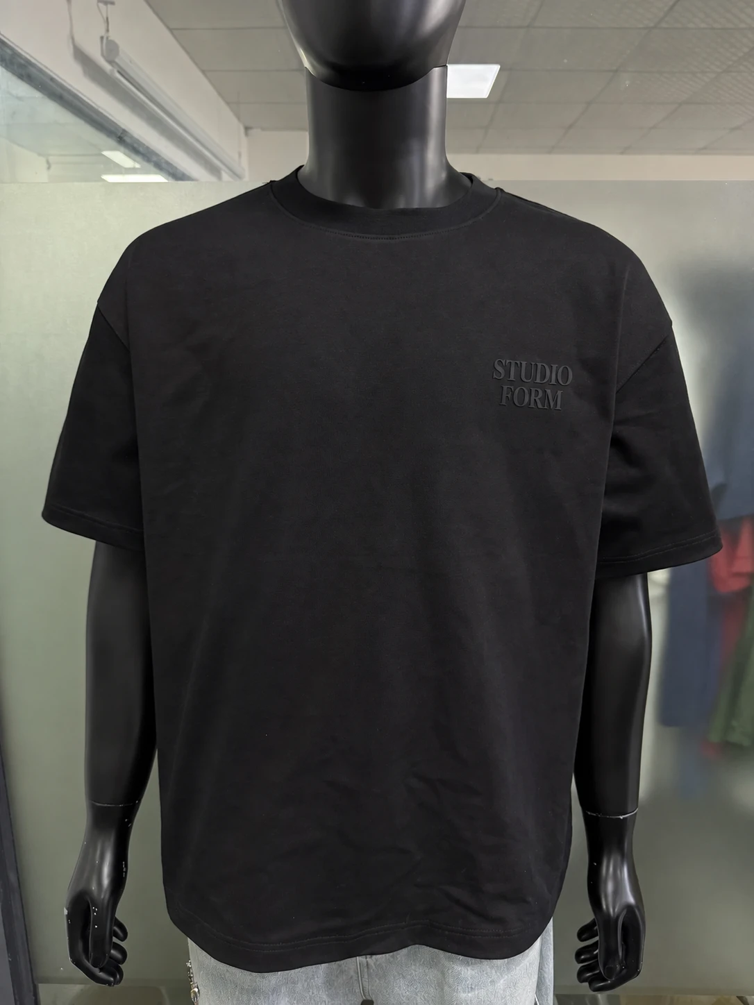 Black T-shirt with a small tonal silicone chest print