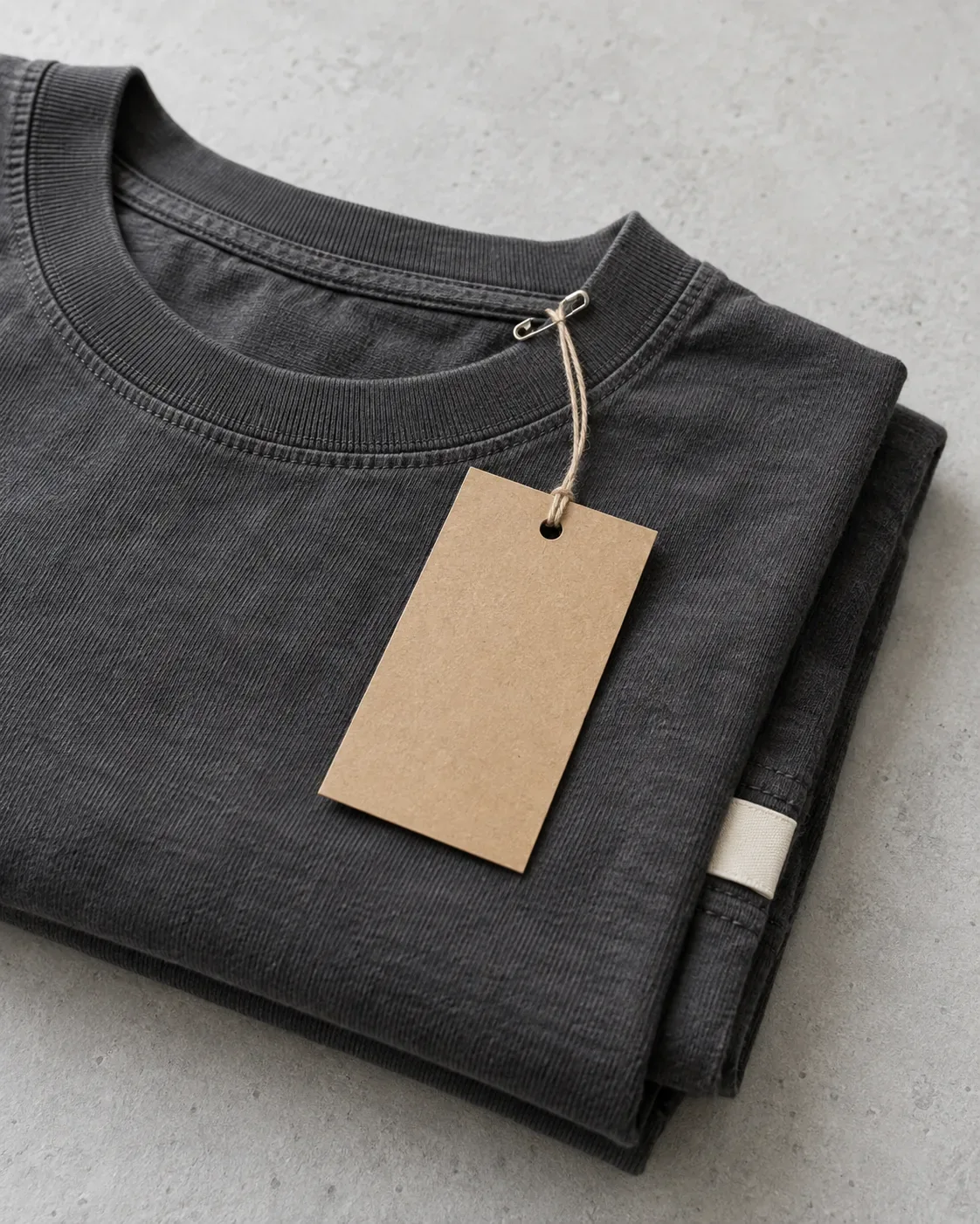 Hang tag and woven hem tab attached to a folded garment