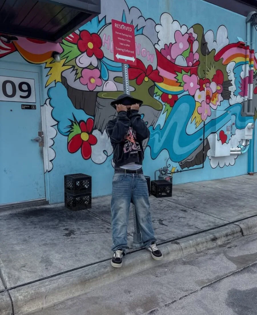 Streetwear look wearing a graphic hoodie outdoors