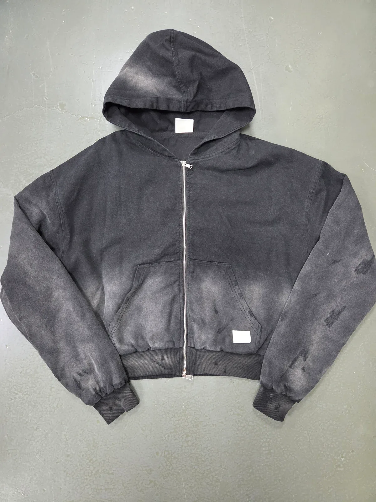 Charcoal zip hoodie sample with washed fabric and a relaxed shape