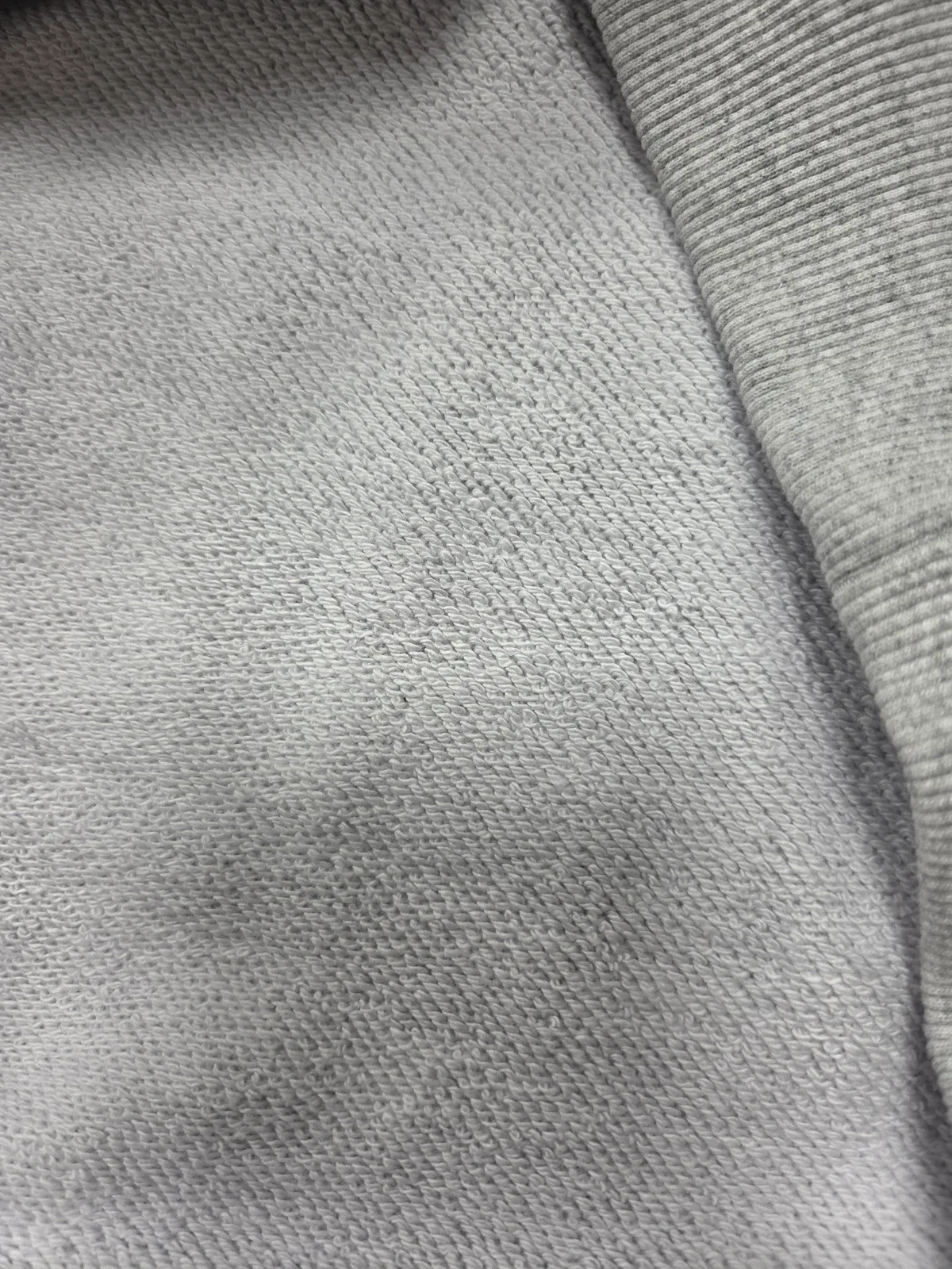 Loopback fabric interior on a grey garment sample