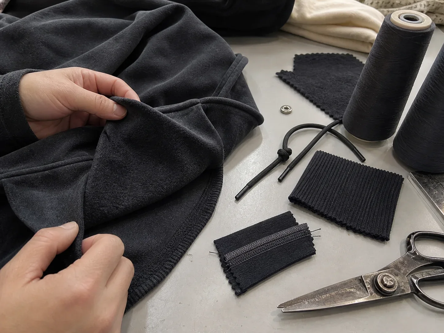 Fleece, rib and trims laid out for a sample decision
