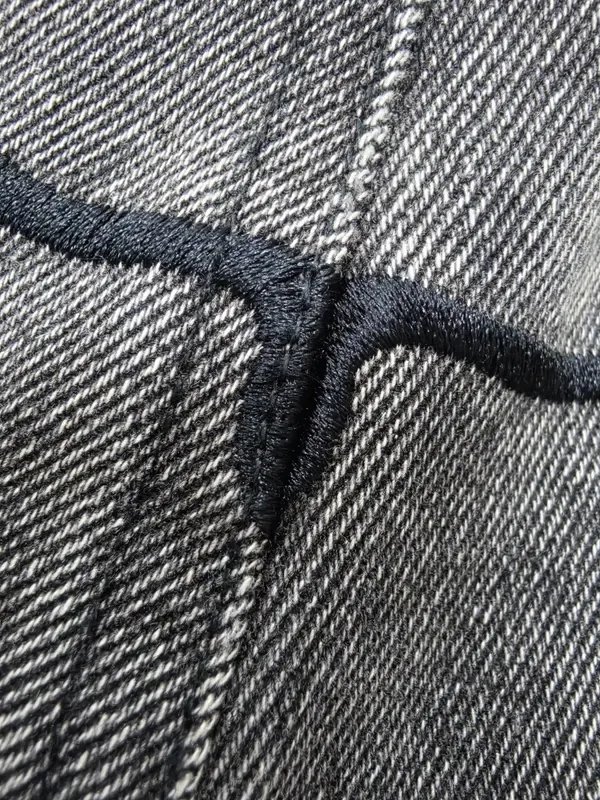 Close-up of stitching and construction on a denim sample