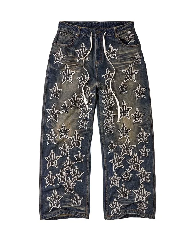Washed dark denim pants with repeated contrasting Vale Star appliqué motifs